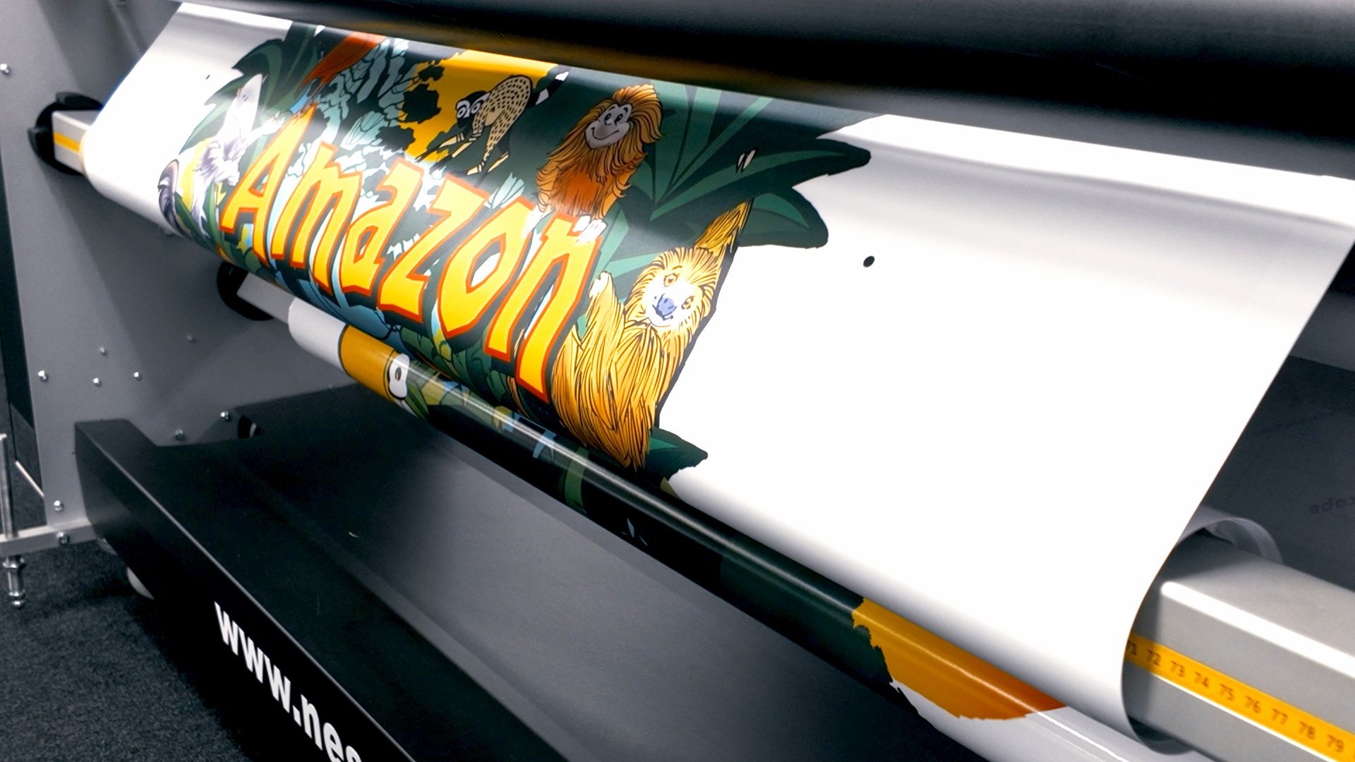 Large-format printer producing the first roll of “Amazon Adventure” signage graphics for Drusillas Park.