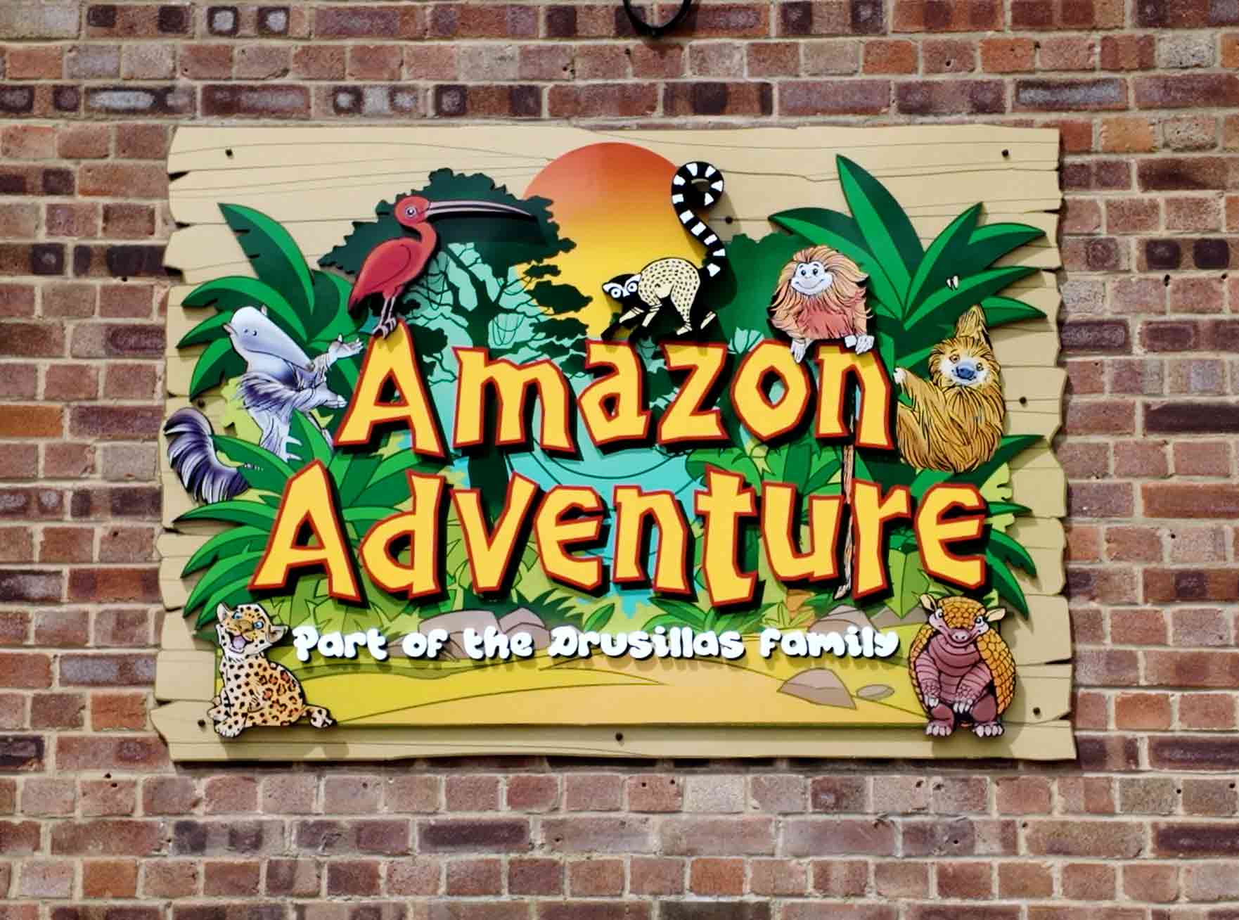 Completed “Amazon Adventure” attraction sign installed on-site at Drusillas Park, featuring vibrant 3D graphics.