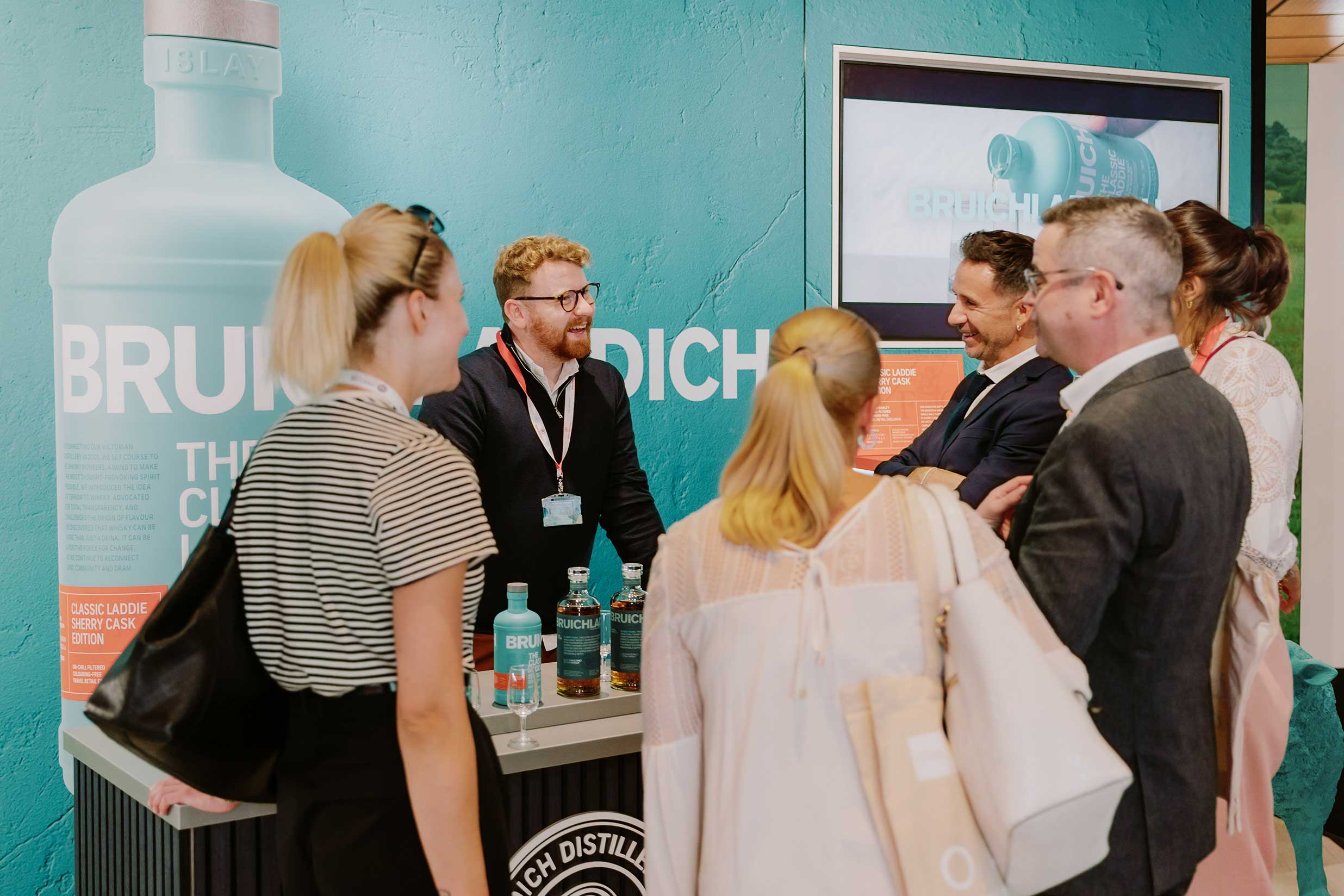 Visitors engaging at the Bruichladdich exhibition stand designed and produced by Beautiful LFP for Rémy Cointreau in Cannes.
