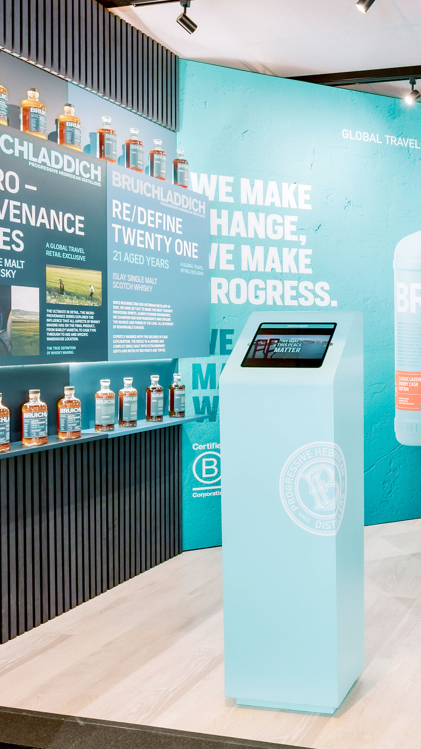 Bruichladdich exhibition stand with turquoise wall, illuminated bottles, and interactive digital display created by Beautiful LFP for Rémy Cointreau.