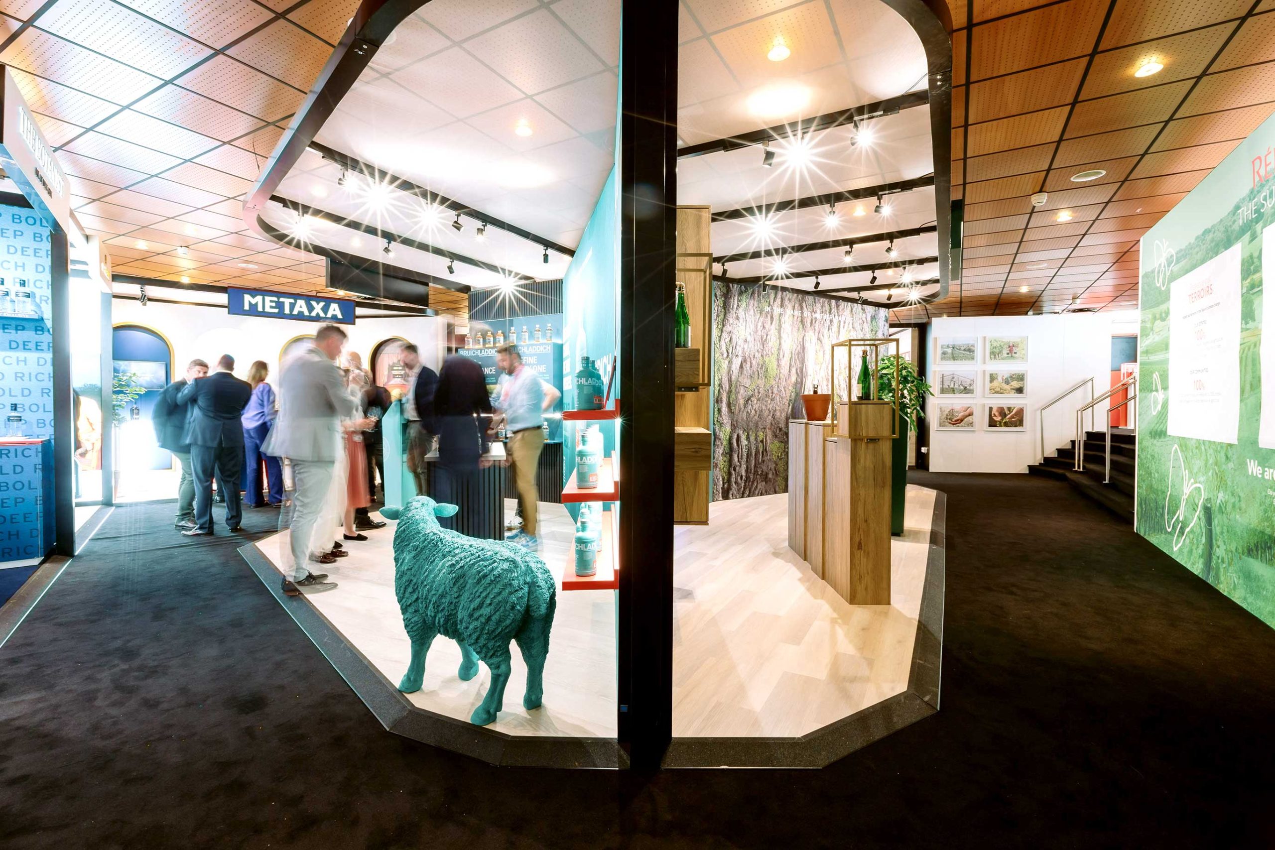Metaxa and Bruichladdich exhibition stands with branded graphics, teal sculpture, and illuminated displays by Beautiful LFP for Rémy Cointreau in Cannes.