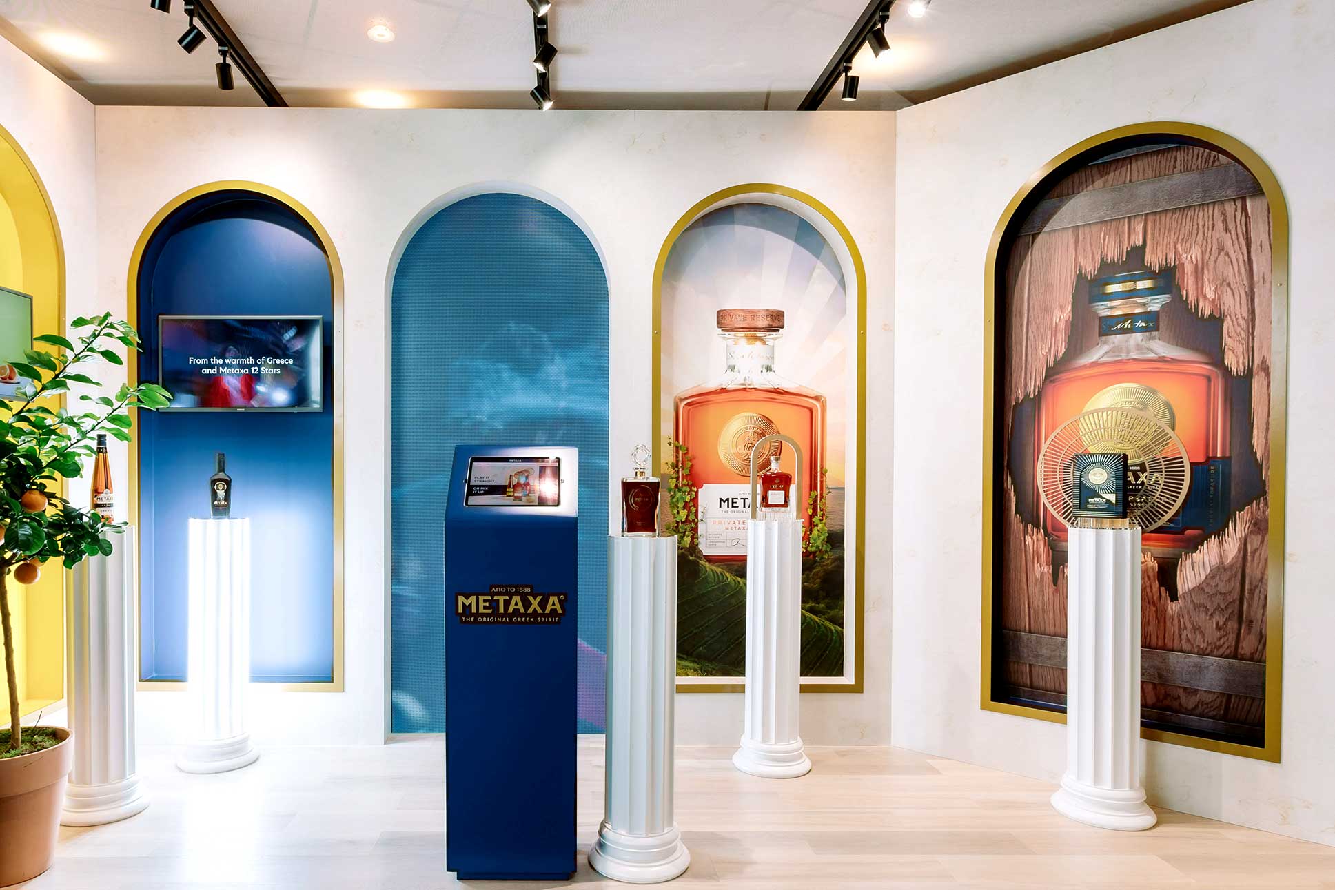 Metaxa exhibition stand with illuminated product displays and printed wall graphics created by Beautiful LFP for Rémy Cointreau in Cannes.