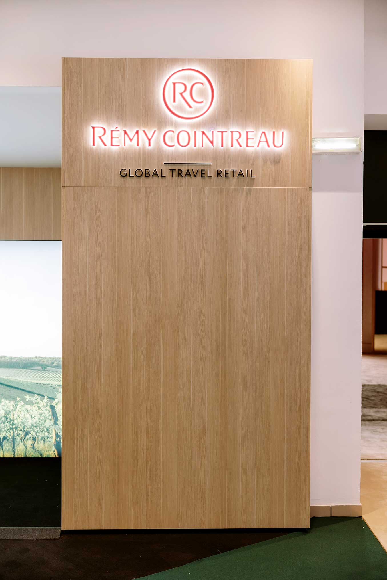 Illuminated Rémy Cointreau Global Travel Retail signage on bespoke exhibition stand designed and printed by Beautiful LFP.