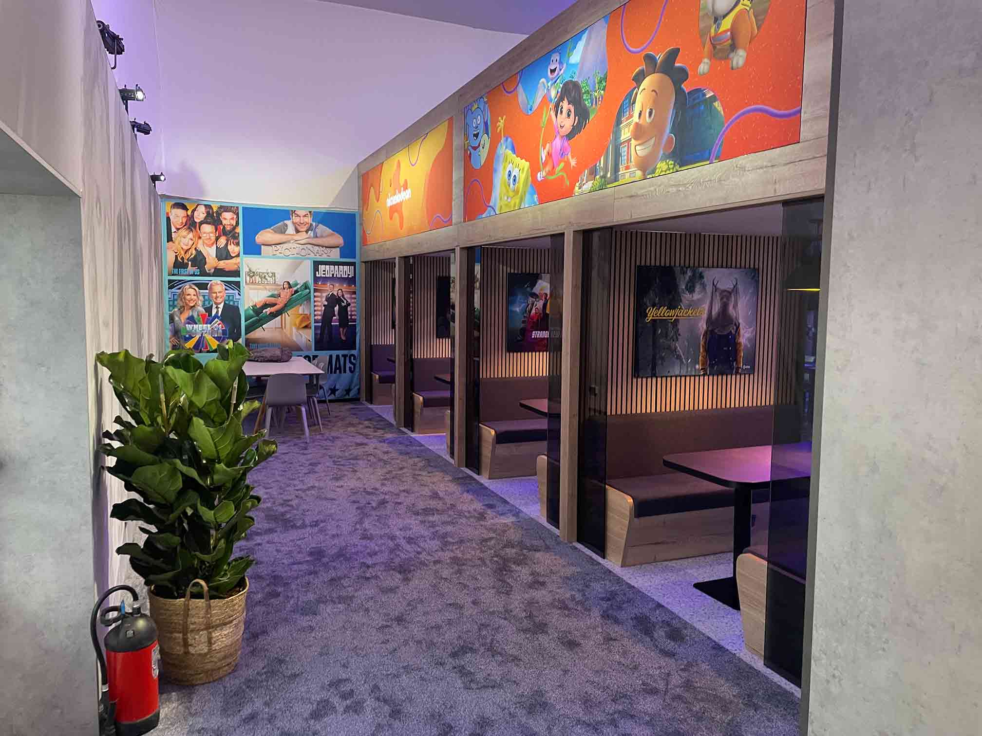 Paramount exhibition stand meeting booths with large-format character wall graphics and illuminated interiors by Beautiful LFP.