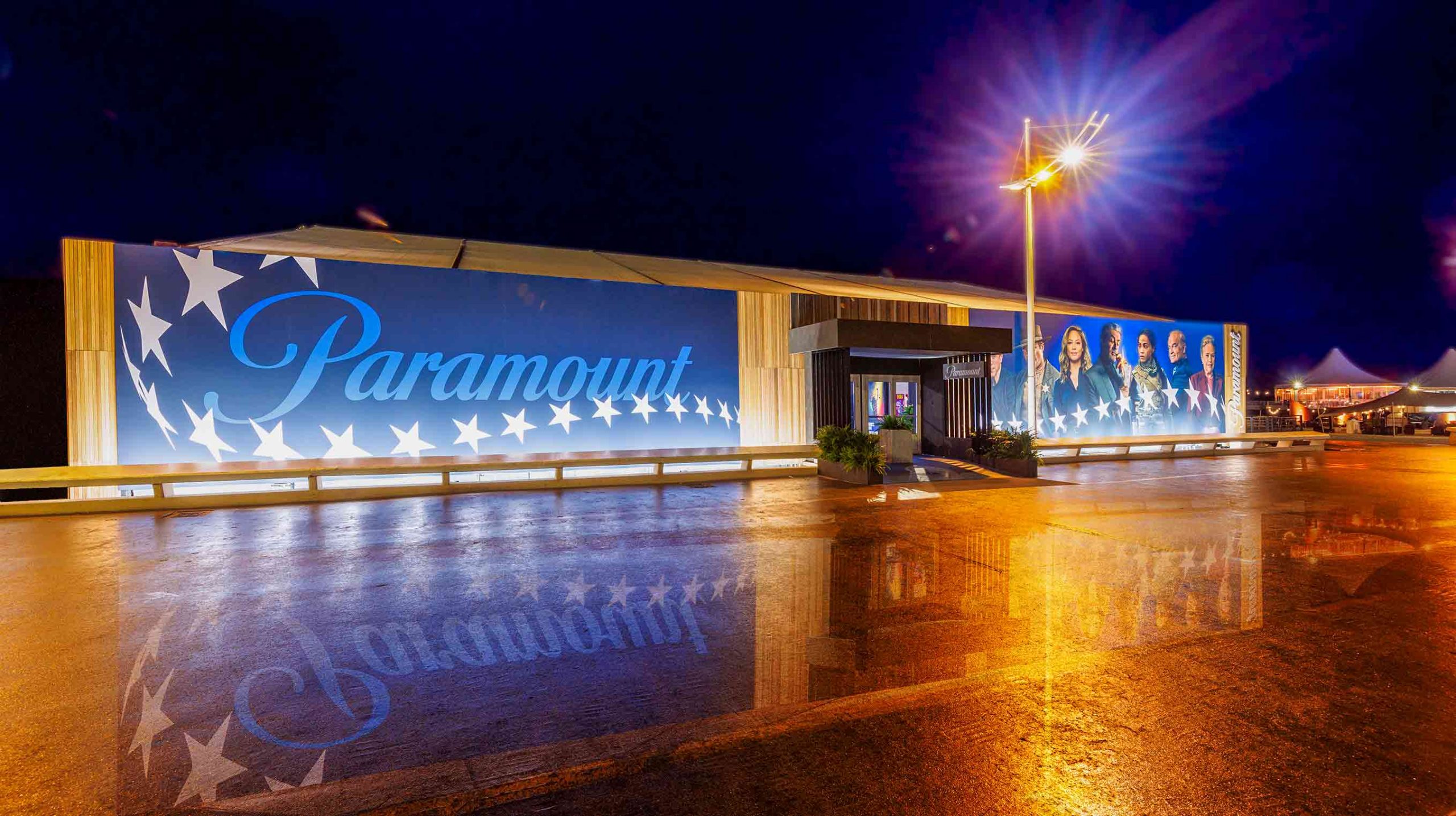 Exterior night view of Paramount exhibition building with illuminated signage and large-format wall graphics by Beautiful LFP.