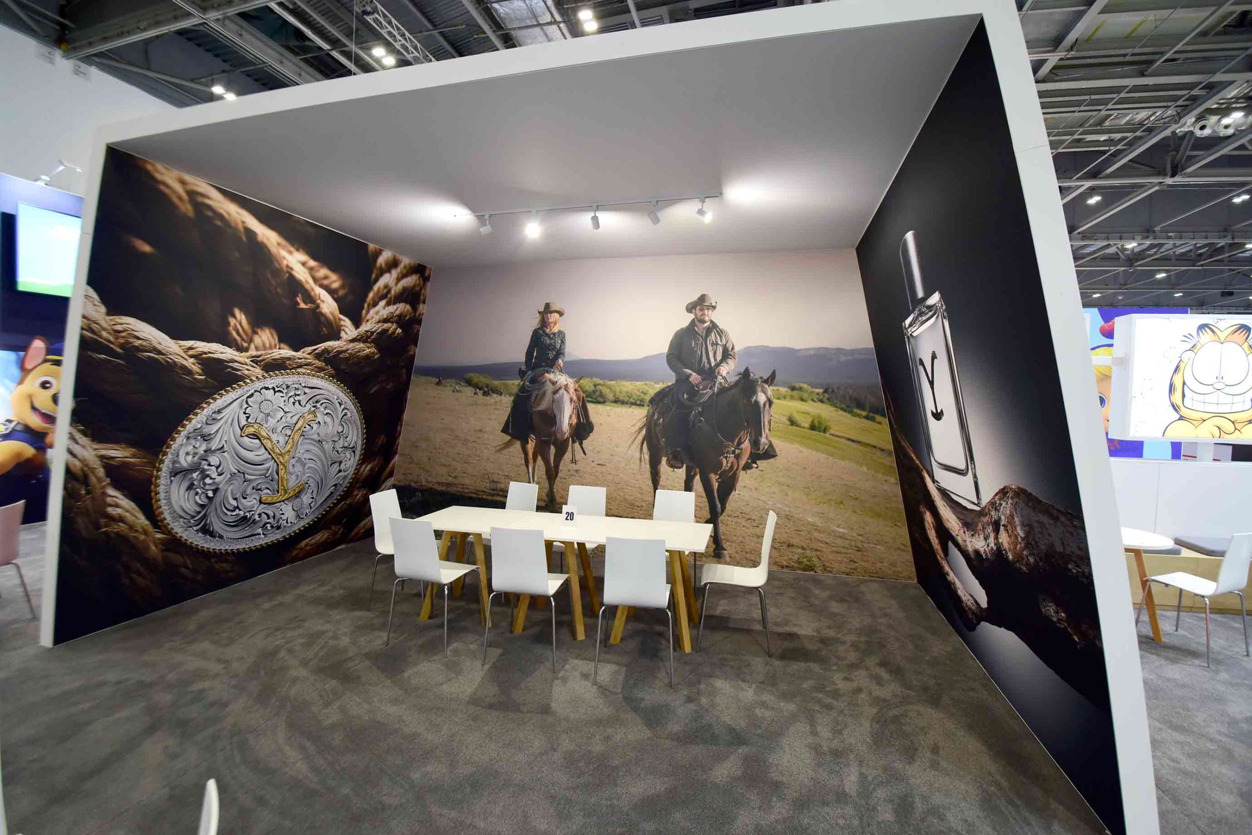 Paramount exhibition stand with Western-themed wall graphics and meeting area printed and installed by Beautiful LFP.