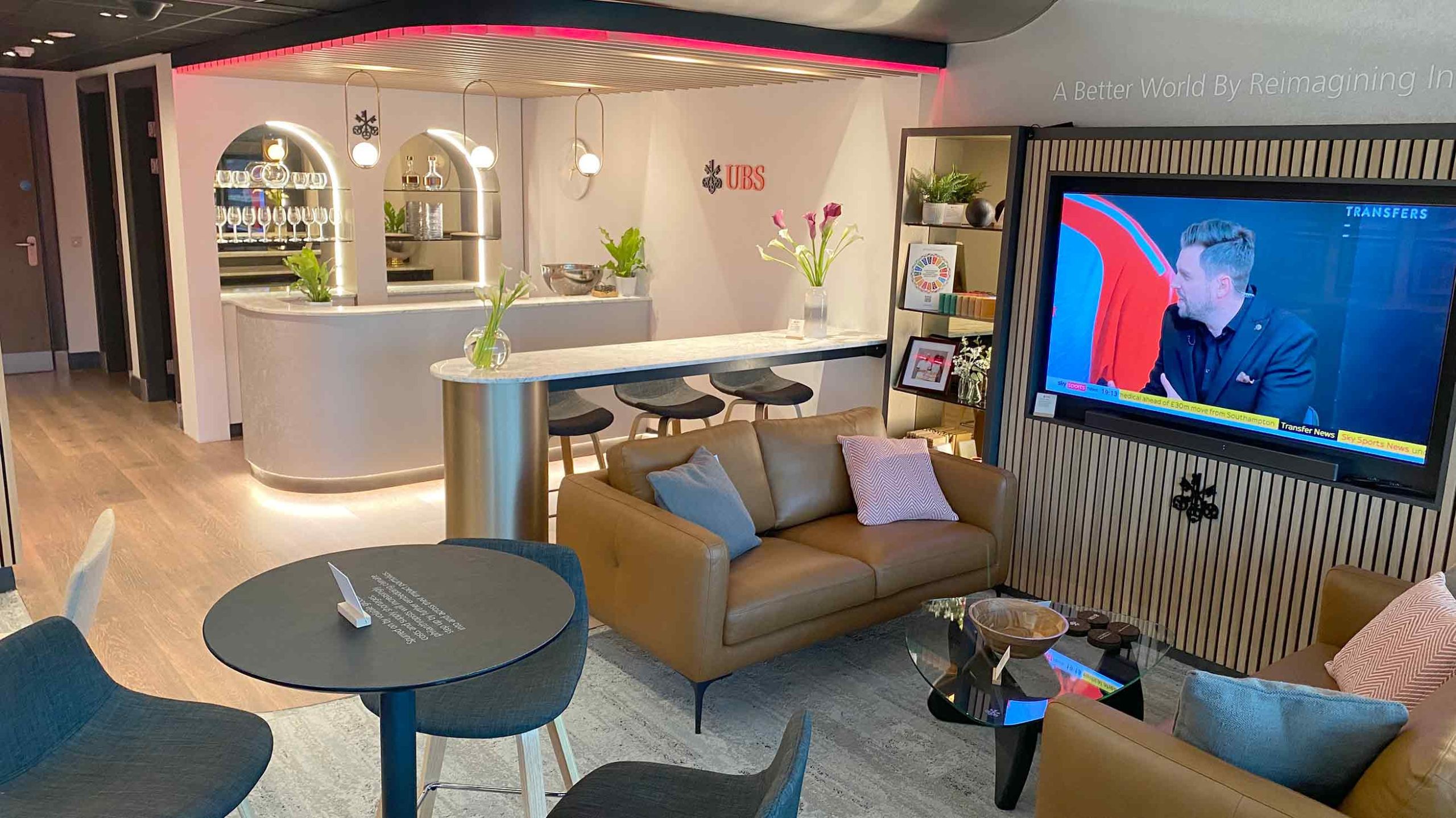 UBS VIP Lounge seating area with bar at Chelsea FC’s Stamford Bridge, designed and printed by Beautiful LFP using luxury materials and branded graphics.