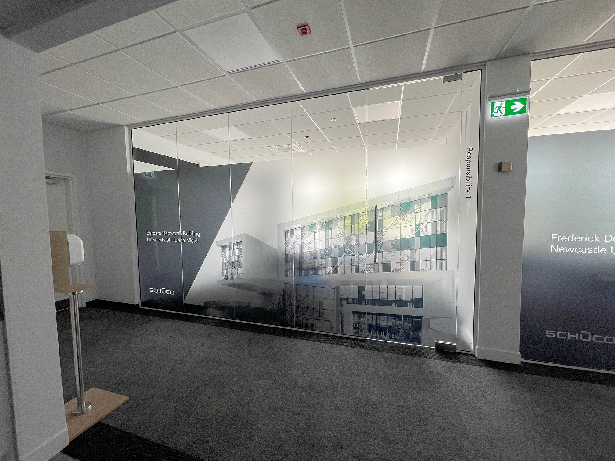 Schüco UK office window vinyl graphics installation in Milton Keynes featuring branded frosted manifestation film