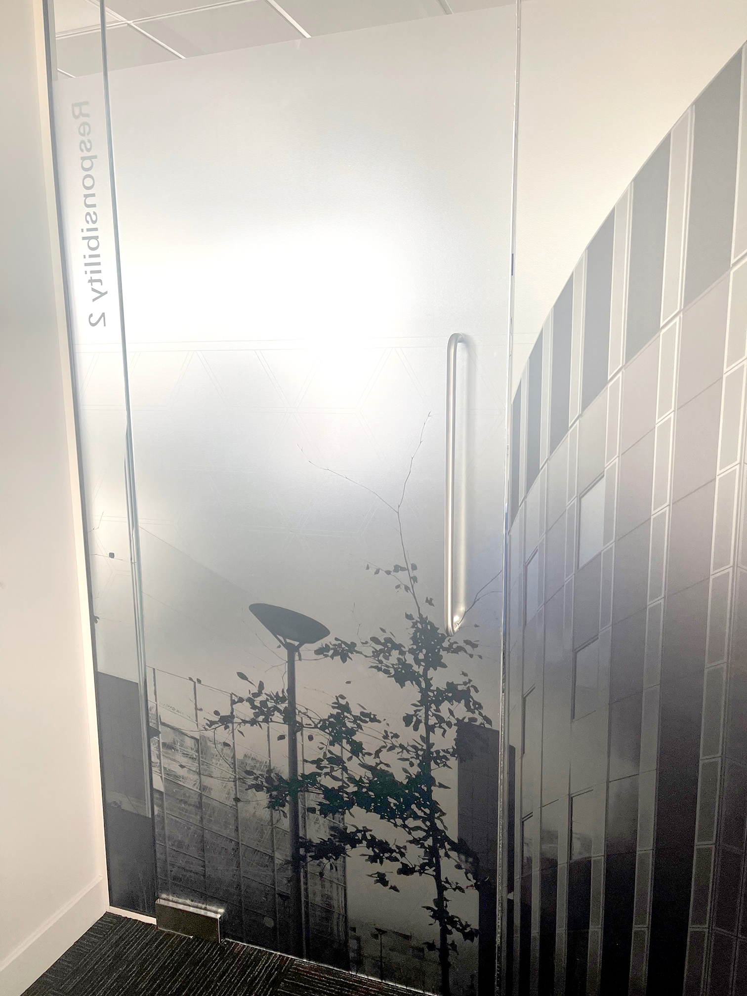 Schüco UK frosted window vinyl graphic installation in Milton Keynes office featuring branded skyline manifestation film